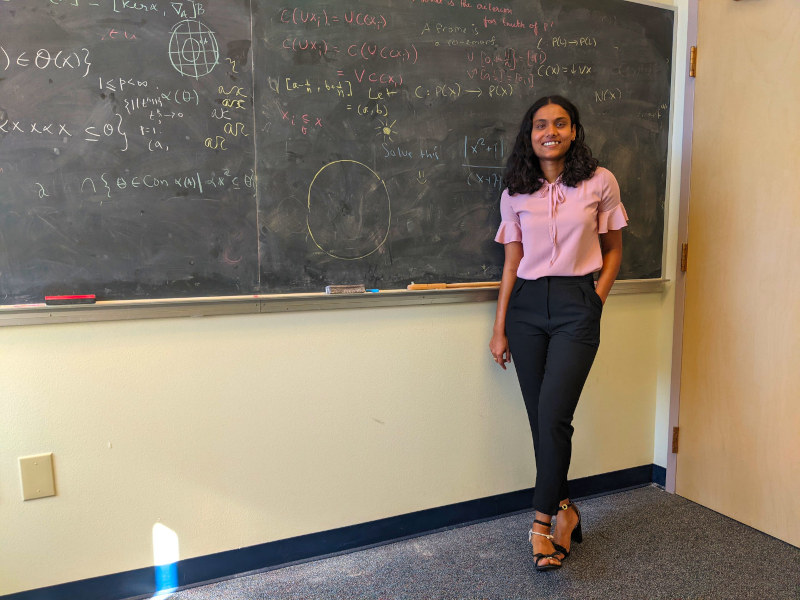 Ranjitha standing in front of a blackboard